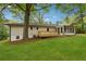 Expansive backyard featuring a deck, sunroom and lawn perfect for outdoor enjoyment at 1232 Andrews Dr, Marietta, GA 30062
