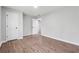 Spacious bedroom with wood-look floors, a door and a light neutral color scheme at 1232 Andrews Dr, Marietta, GA 30062