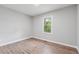 Bright bedroom showcasing wood-look floors and a window view of lush greenery at 1232 Andrews Dr, Marietta, GA 30062