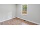Neutral bedroom featuring wood floors and a window offering natural light at 1232 Andrews Dr, Marietta, GA 30062