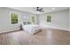 Bright main bedroom featuring wood-look floors, a fan and a large picture window at 1232 Andrews Dr, Marietta, GA 30062