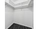 Clean and simple walk-in closet design with black tile floor, providing functional storage space at 1232 Andrews Dr, Marietta, GA 30062