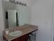 Bathroom showcasing a marble vanity with a large mirror and vanity lights, and view into an adjacent room at 1325 Sandlewood Ct, Lithonia, GA 30058