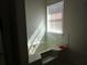 Brightly lit bathtub area with tiled walls and window at 1325 Sandlewood Ct, Lithonia, GA 30058