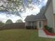 Home with a brick facade, nice landscaping, green grass and a fenced in yard at 1325 Sandlewood Ct, Lithonia, GA 30058