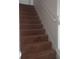 Carpeted stairs with white handrail leading to the next level at 1325 Sandlewood Ct, Lithonia, GA 30058