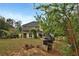 View of the home's backyard with mature trees and lawn at 159 Molly Way, Mcdonough, GA 30253