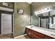 Bathroom with double granite sink vanity, tile flooring, designer paint, framed mirrors and modern lighting at 159 Molly Way, Mcdonough, GA 30253
