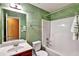Bathroom featuring a single sink vanity, toilet, bathtub with tile surround, and designer paint at 159 Molly Way, Mcdonough, GA 30253