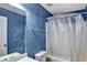 Close-up of a bathroom shower/tub combo with blue textured walls and sink to the left at 159 Molly Way, Mcdonough, GA 30253