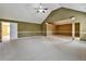 Spacious bedroom with a vaulted ceiling, fan, neutral carpet, and an attached room at 159 Molly Way, Mcdonough, GA 30253