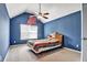 Bedroom featuring blue walls, vaulted ceiling and fan, plus natural light at 159 Molly Way, Mcdonough, GA 30253
