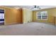 Spacious bedroom featuring yellow walls, neutral carpet, a fan, and natural light at 159 Molly Way, Mcdonough, GA 30253