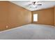 Bedroom with carpeted floors, tan walls, ceiling fan and a view of a window at 159 Molly Way, Mcdonough, GA 30253
