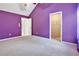 Bedroom features a sizable closet with plush carpet, complemented by adjacent doors and walls painted in vibrant colors at 159 Molly Way, Mcdonough, GA 30253
