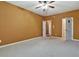 Spacious bedroom with plush carpeting, ceiling fan, neutral walls, and multiple doors at 159 Molly Way, Mcdonough, GA 30253
