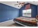 Bright bedroom with blue walls, vaulted ceiling and a fan, also includes a window at 159 Molly Way, Mcdonough, GA 30253