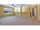 Spacious bedroom space with yellow walls, natural light, neutral carpet, and a fan at 159 Molly Way, Mcdonough, GA 30253