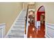Inviting entryway with hardwood floors, staircase, and elegant archway to adjoining rooms at 159 Molly Way, Mcdonough, GA 30253