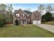 Charming brick two-story home with a manicured lawn, a two-car garage, and mature landscaping at 159 Molly Way, Mcdonough, GA 30253