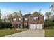 Classic brick home with a two-car garage, traditional shutters, and a lovely front lawn at 159 Molly Way, Mcdonough, GA 30253