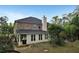 Rear exterior view of a brick home with an enclosed patio and landscaping at 159 Molly Way, Mcdonough, GA 30253