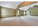 Bright living room with high vaulted ceilings, large windows and neutral carpeting at 159 Molly Way, Mcdonough, GA 30253
