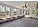 Bright sunroom featuring ample windows with backyard views, a ceiling fan, and white trim at 159 Molly Way, Mcdonough, GA 30253