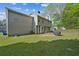 Spacious backyard featuring a lush lawn and mature trees at 3937 Sautee Trl, Conley, GA 30288