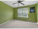 Bright bedroom features a ceiling fan, large window, and neutral carpeting at 3937 Sautee Trl, Conley, GA 30288