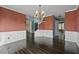 Formal dining room with hardwood floors, wainscoting, chandelier, and views into the foyer at 3937 Sautee Trl, Conley, GA 30288
