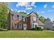 Two-story brick home with a well-manicured lawn, red shutters, and a chimney at 3937 Sautee Trl, Conley, GA 30288