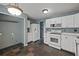 Kitchen with stainless appliances, light cabinetry, and an adjacent laundry area at 3937 Sautee Trl, Conley, GA 30288