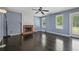 Bright living room with hardwood floors, a brick fireplace, and natural light at 3937 Sautee Trl, Conley, GA 30288