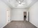 Spacious bedroom with plush carpeting, tray ceiling, and open doorway at 609 Alyssa Ct, Locust Grove, GA 30248