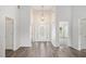 Bright entryway with high ceilings, chandelier, and decorative glass front door at 609 Alyssa Ct, Locust Grove, GA 30248