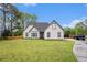 Well-kept single-story home with a lush lawn, mature trees, and inviting driveway at 609 Alyssa Ct, Locust Grove, GA 30248