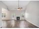 Spacious living room features a fireplace, vaulted ceilings, and natural light at 609 Alyssa Ct, Locust Grove, GA 30248
