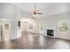 Open-concept living room with a fireplace, hardwood floors, and access to the kitchen at 609 Alyssa Ct, Locust Grove, GA 30248
