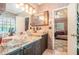 Stone vessel sinks and granite countertops bring earthy elements to this stylish bathroom at 125 Russell Rd, Lawrenceville, GA 30043