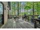 Enjoy outdoor dining on the spacious deck with a wooded view, perfect for entertaining and relaxation at 125 Russell Rd, Lawrenceville, GA 30043