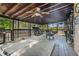 Relax on this outdoor deck featuring a hot tub, grilling area, and porch swing with a wooded view at 125 Russell Rd, Lawrenceville, GA 30043