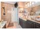 Modern main bathroom showcasing stone vessel sinks and a walk-in shower at 125 Russell Rd, Lawrenceville, GA 30043