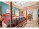 Comfortable main bedroom featuring a four-poster bed and ample closet space at 125 Russell Rd, Lawrenceville, GA 30043