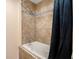 Bathroom featuring a bathtub and shower with tile surround at 2161 Peachtree Ne Rd # 402, Atlanta, GA 30309