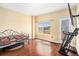 Bright bedroom featuring hardwood floors, a large window and a doorway with a view of the city at 2161 Peachtree Ne Rd # 402, Atlanta, GA 30309