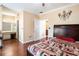 Comfortable bedroom featuring hardwood floors, ceiling fan and doorway leading to a bathroom at 2161 Peachtree Ne Rd # 402, Atlanta, GA 30309