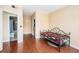 A cozy bedroom featuring hardwood floors, a modern ceiling fan and a doorway leading to a bathroom at 2161 Peachtree Ne Rd # 402, Atlanta, GA 30309