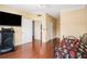 A cozy bedroom featuring hardwood floors, a modern ceiling fan and a doorway leading to a bathroom at 2161 Peachtree Ne Rd # 402, Atlanta, GA 30309