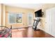 Bright bedroom featuring hardwood floors, a large window and a doorway with a view of the city at 2161 Peachtree Ne Rd # 402, Atlanta, GA 30309